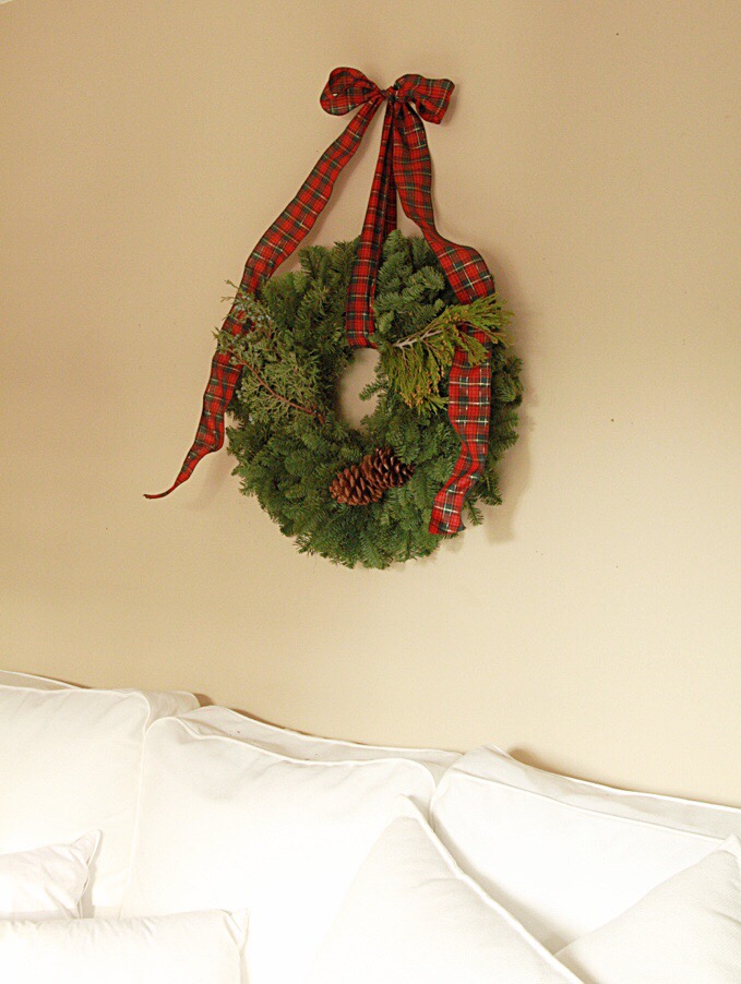 A green wreath hanging on the wall.