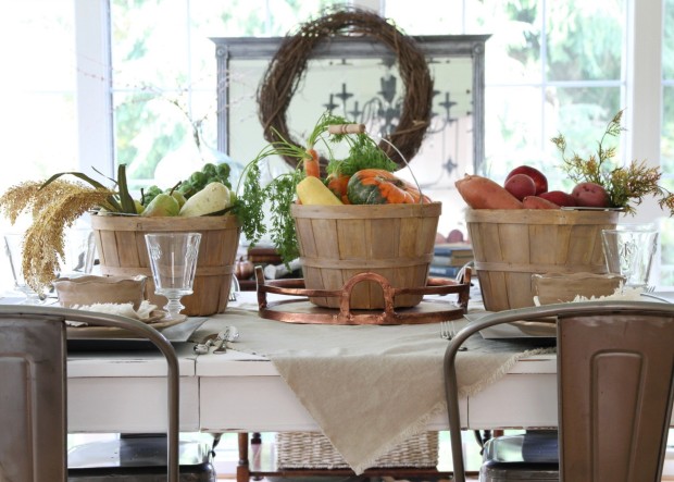 3 buckets filled with vegetables on the table with a wreath behind it.