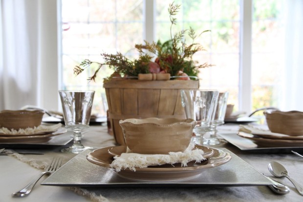 Thanksgiving table setting with wooden centerpiece.