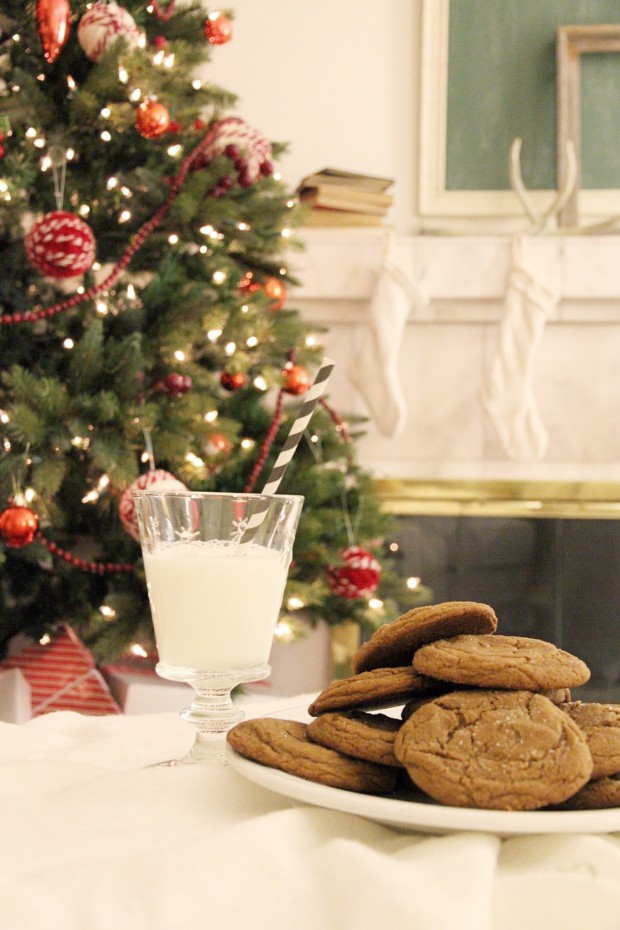 Decorated Christmas tree, a glass of milk, molasses cookies on a plate.