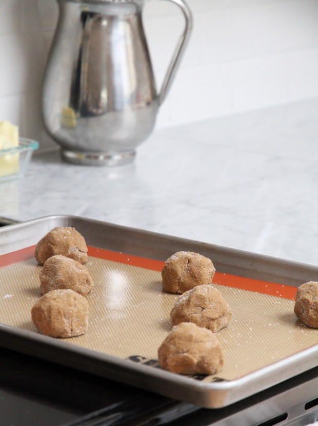 Cookie dough balls on a cookie sheet ready to be baked.