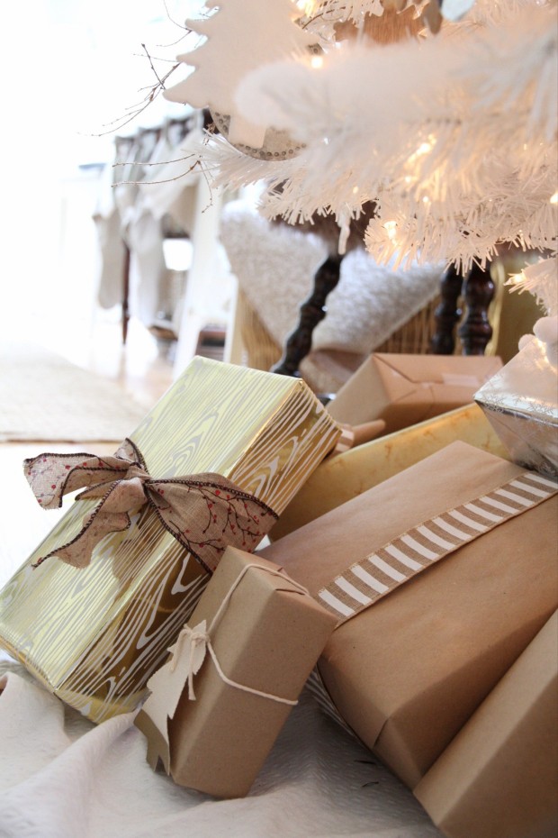 A gold foil wrapped present with a fabric ribbon tied around it.