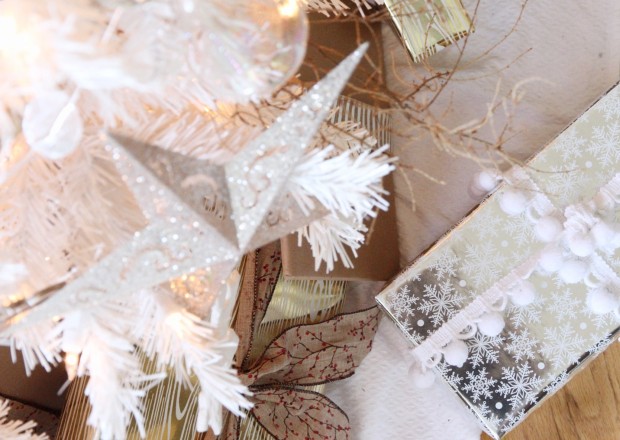 A silver wrapped present with white ribbon under the tree.