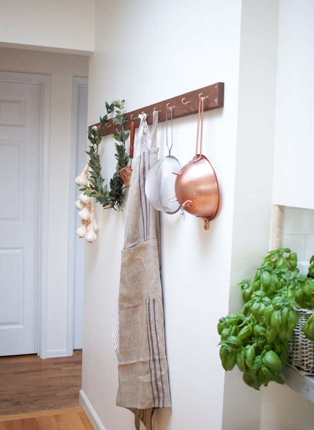 Laurel wreath, an apron, pots on hooks in the kitchen.