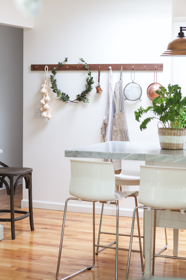 The marble island, chairs, and green plant on the island.