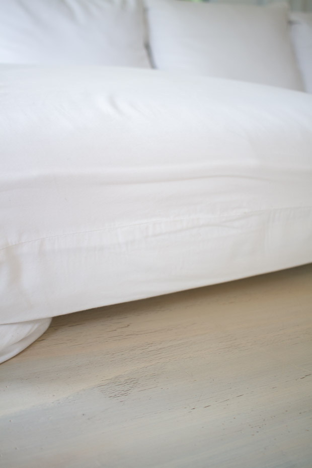 White couch on wooden floor.