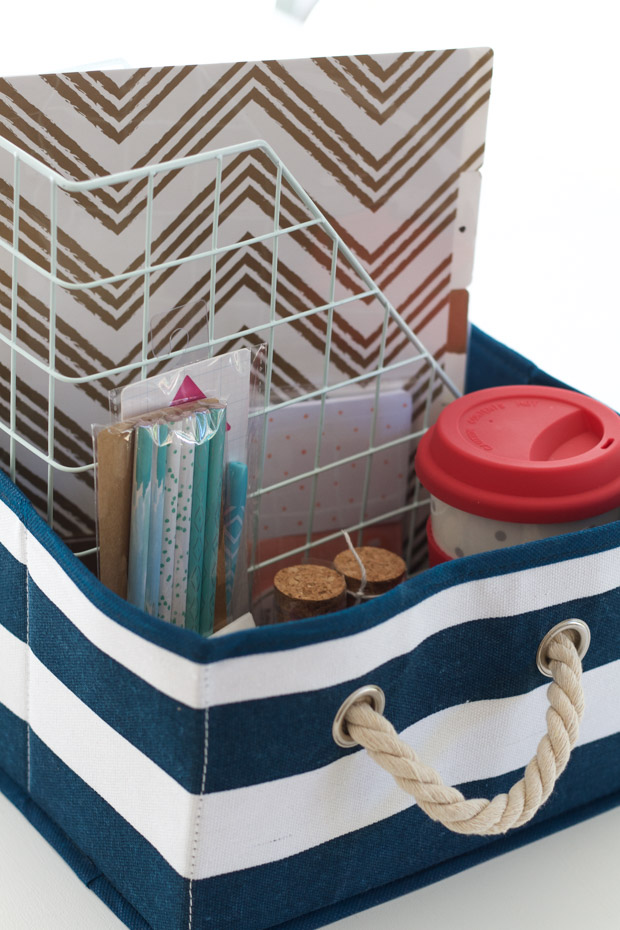 Blue and white striped gift basket filled with school items.