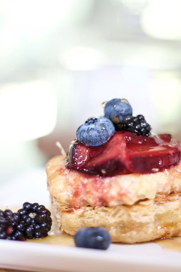 Blackberries, blueberries on top of pastry shell that is baked.