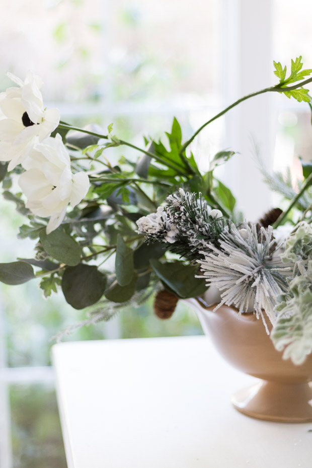 The white flowers, and pine sticking out of the bowl.