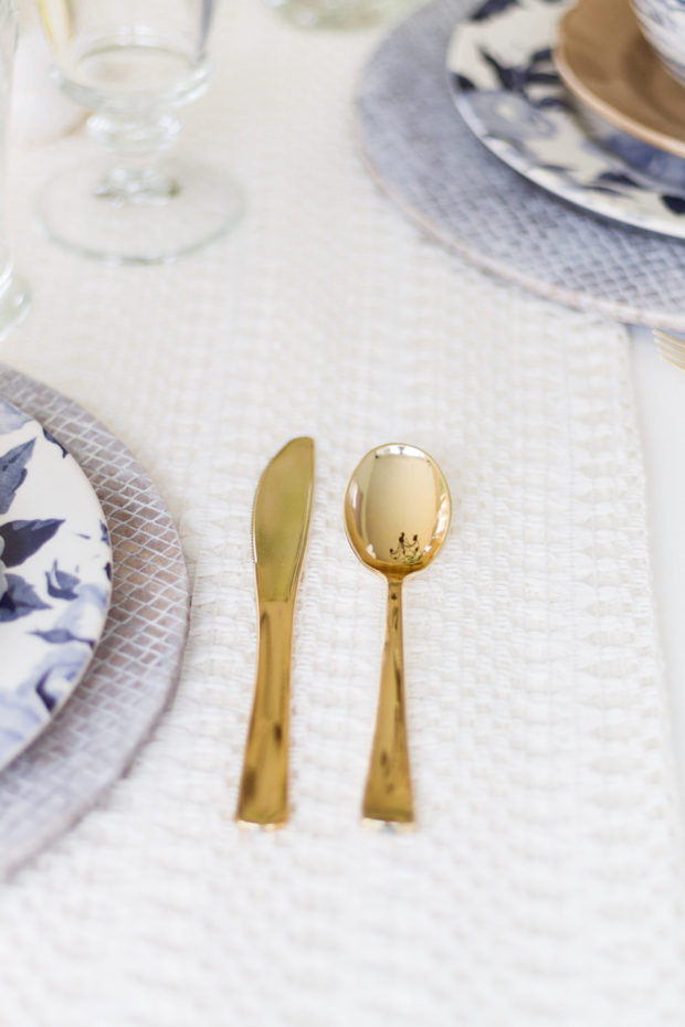 A gold spoon and knife on the table.