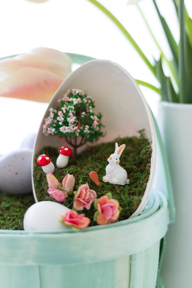 Up close of the little bunny, tree mushrooms, and flowers inside the plastic egg.