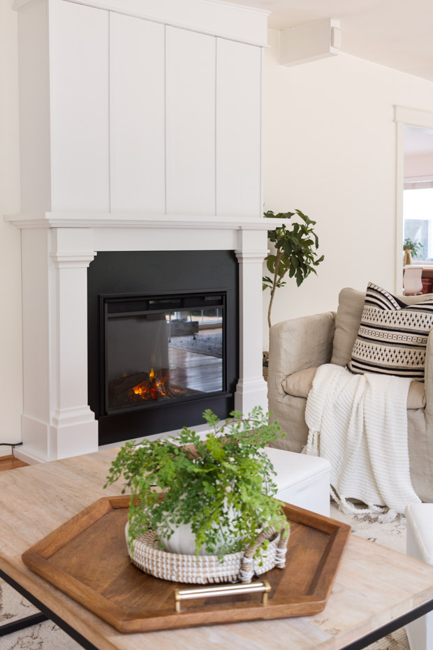 White mantel and black fireplace.