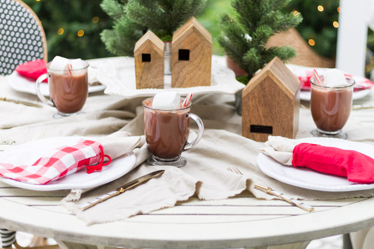 Simple Outdoor Christmas Table Decorating with wooden birdhouses.