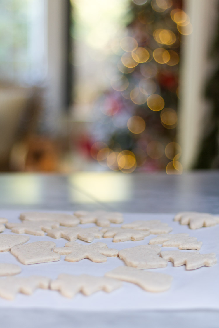Spreading the cookies on the parchment paper before decorating them.
