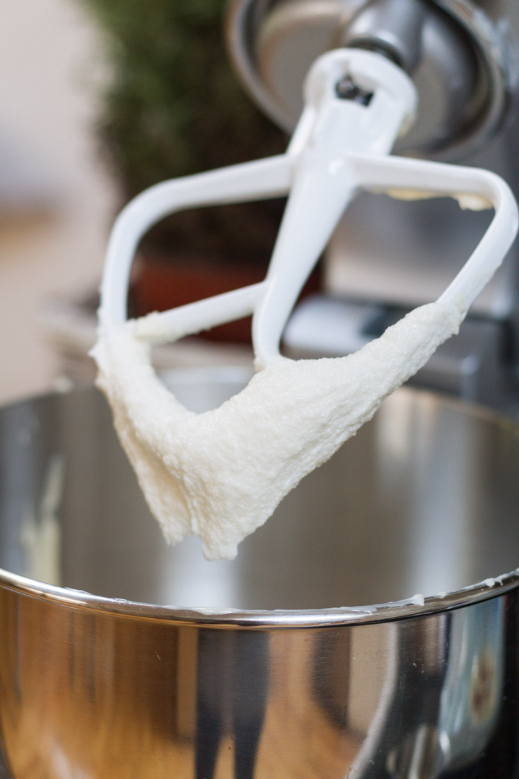 A mixing bowl with the attachment half out with batter on it.
