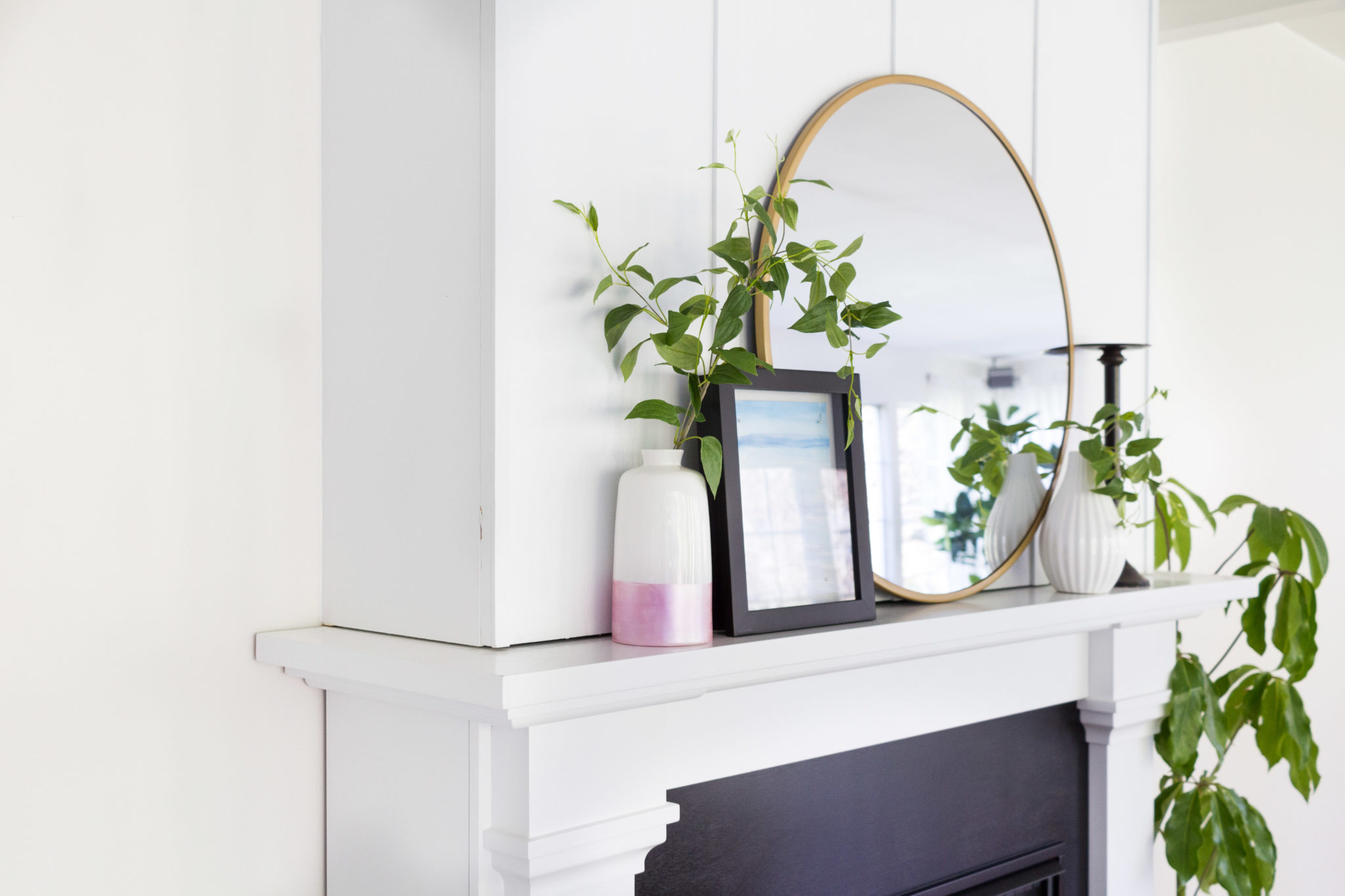 A miniature white vase on the mantel.