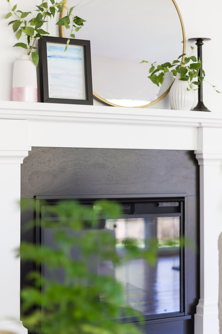 Black fireplace with a white mantel.