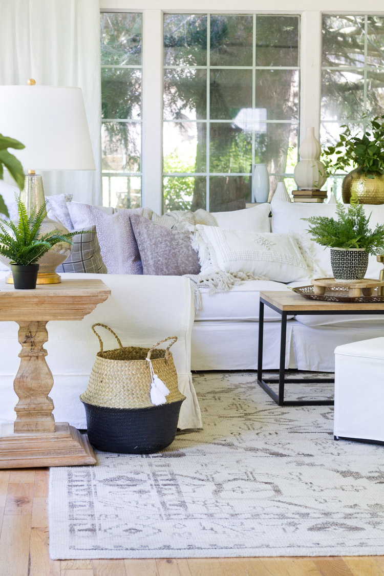 Family room with white couch and large rug.