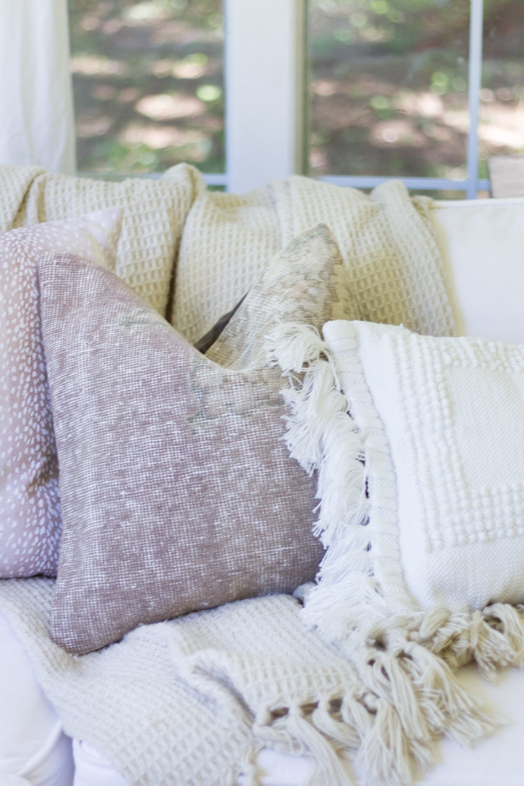 Pale light colored pillows on couch.