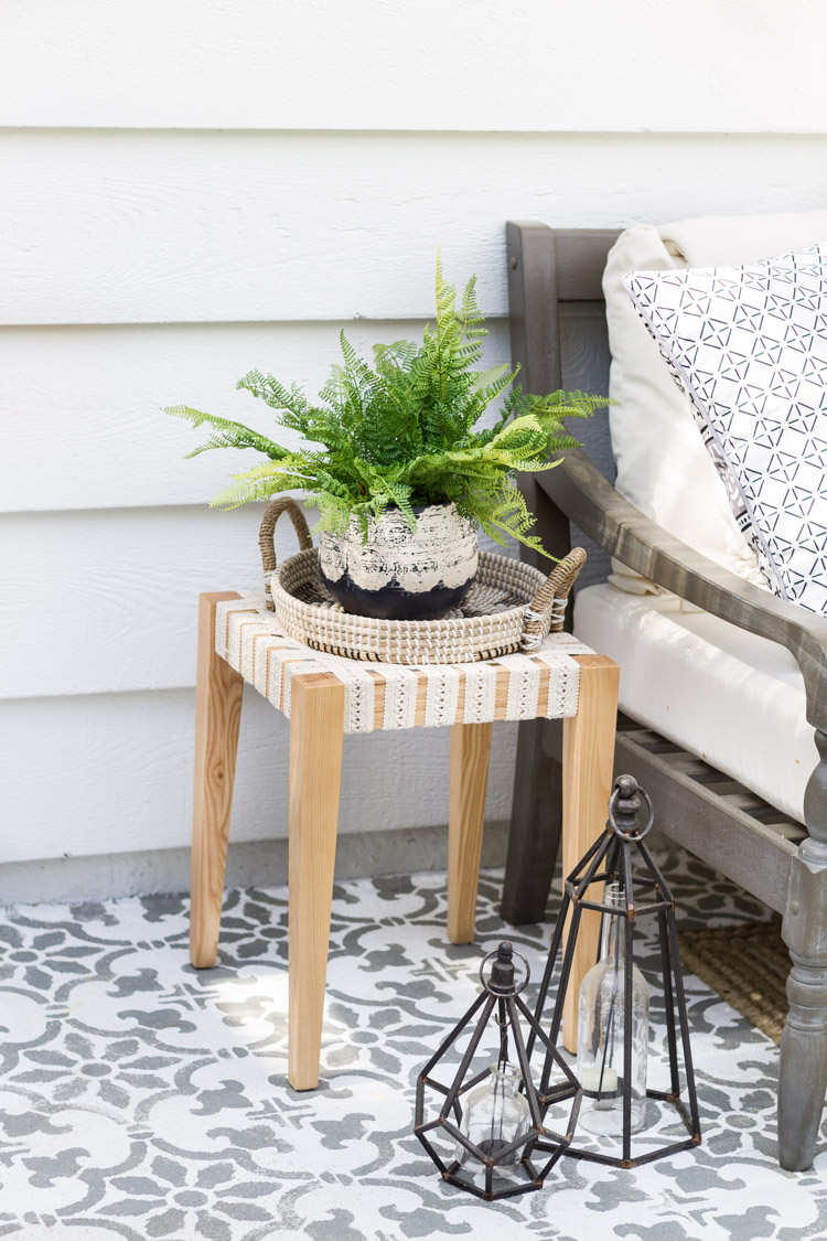 A wooden side table with a plant on it.