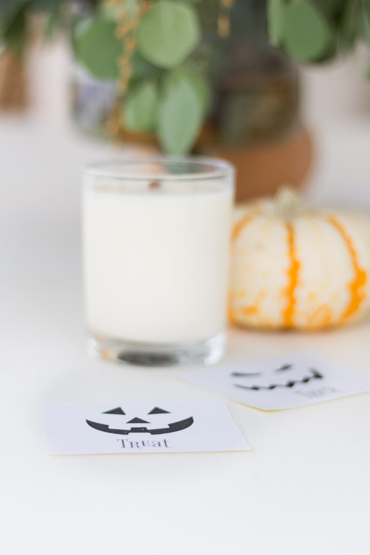 The trick or treat stickers on the counter by the candle.