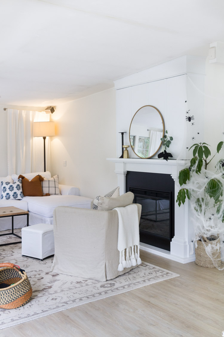 Neutral sitting room with light wooden floors and fireplace.