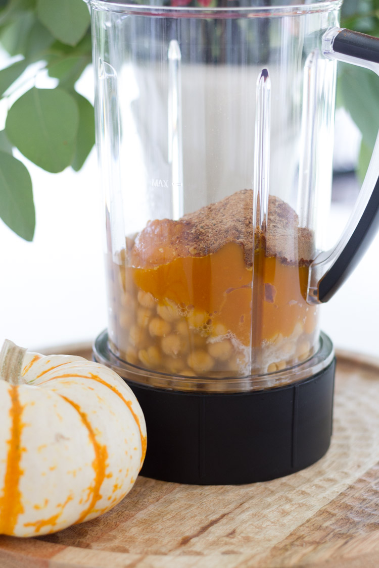 Blender with chick peas and pumpkin in it.