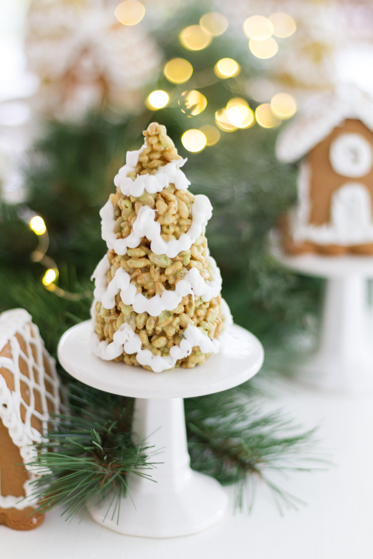 A white mini cake stand with a Rice Krispie tree on it.