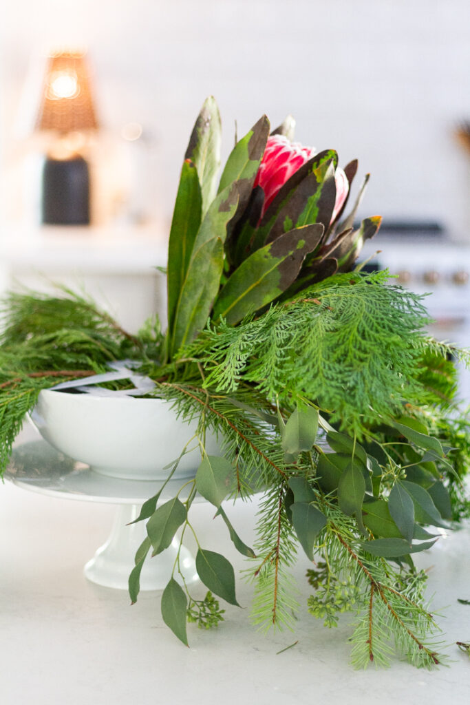 Christmas floral arrangement using a cake stand and a bowl