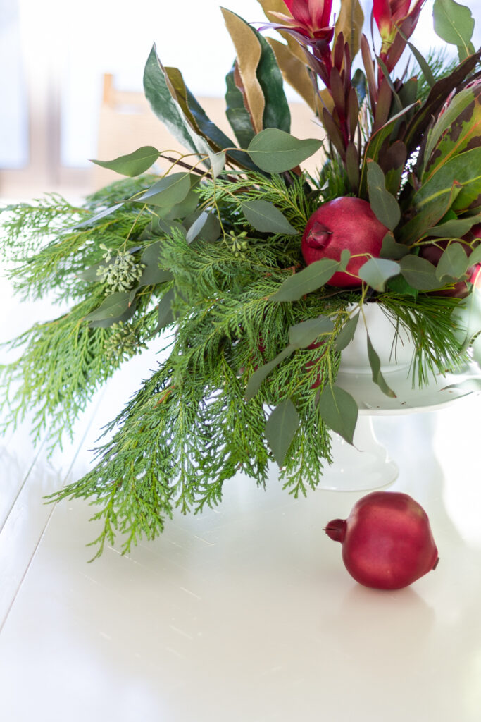 Christmas floral arrangement using a cake stand and a bowl